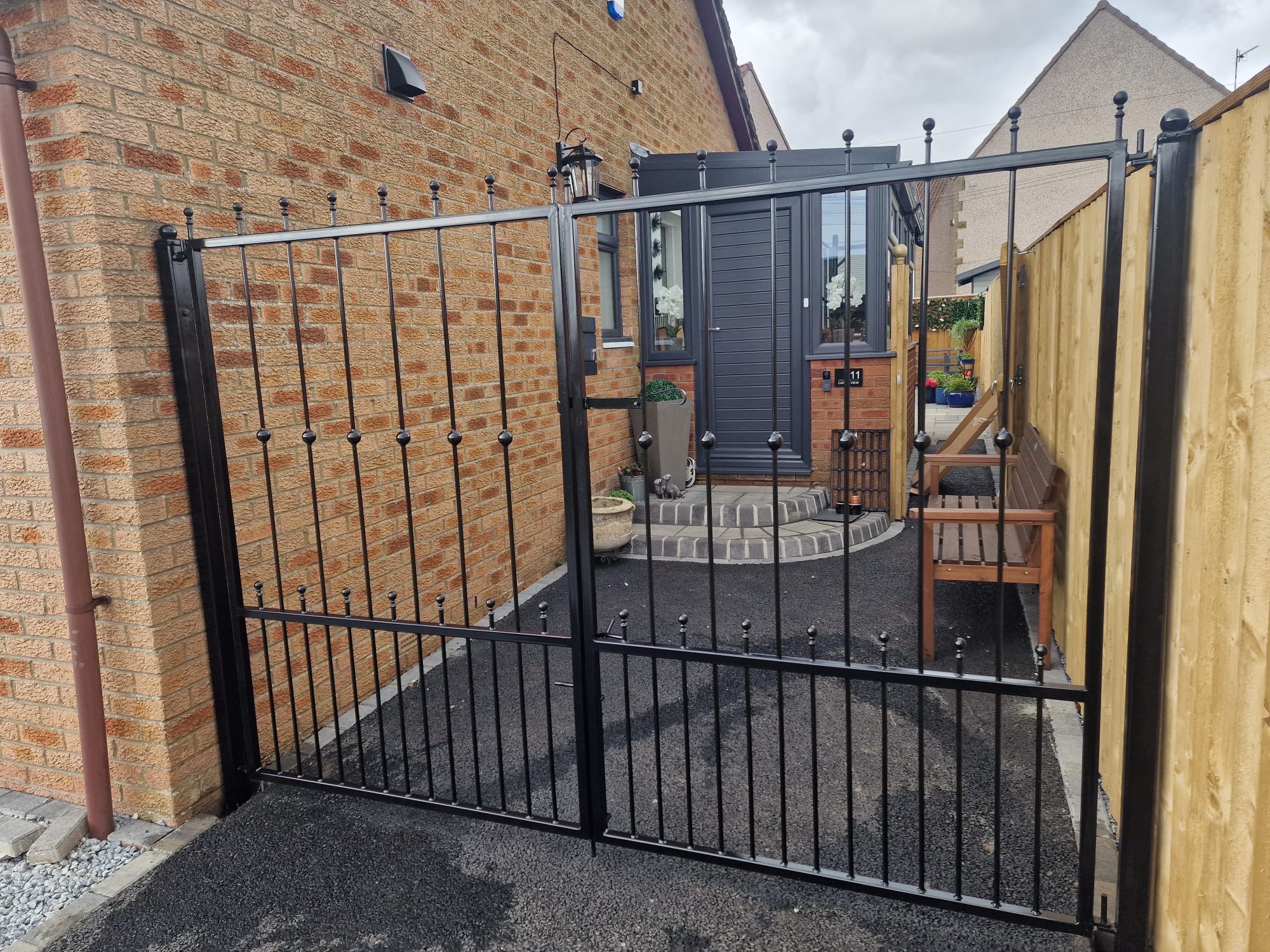 Wrought iron double gates with spear finials